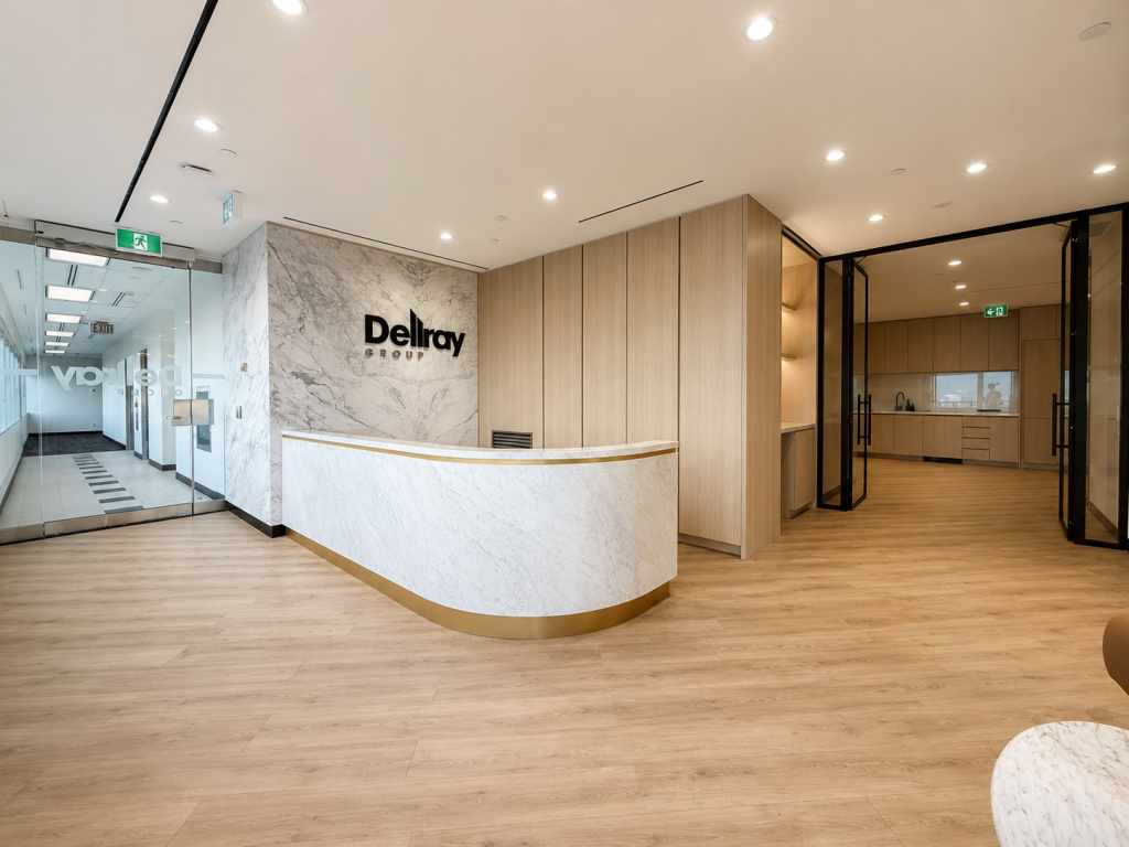 Modern corporate office reception featuring custom curved marble reception desk, architectural wood wall panels, integrated millwork systems, and premium workplace interiors by Boreal Architectural.