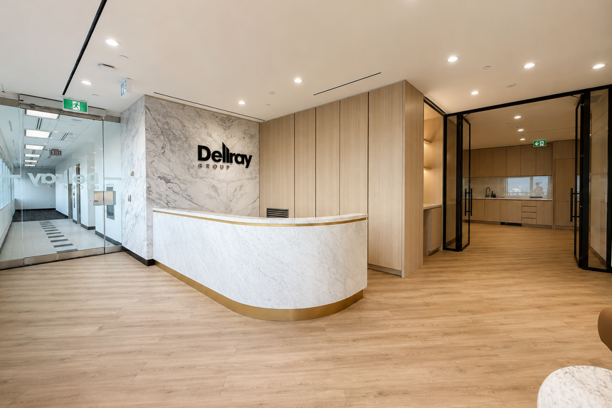 Modern corporate office reception featuring custom curved marble reception desk, architectural wood wall panels, integrated millwork systems, and premium workplace interiors by Boreal Architectural.