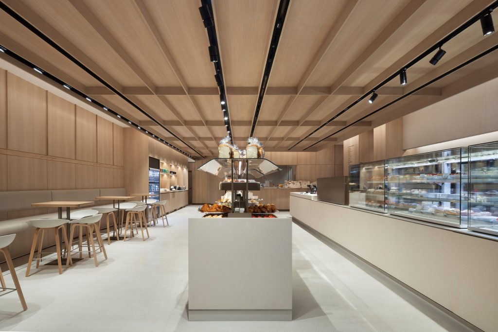 Custom retail millwork and architectural woodwork fabricated for a contemporary commercial bakery and café environment.