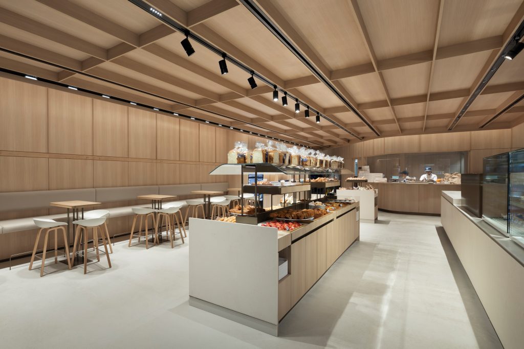 Modern hospitality interior with premium architectural millwork, custom wood wall cladding, and commercial wood finishes.