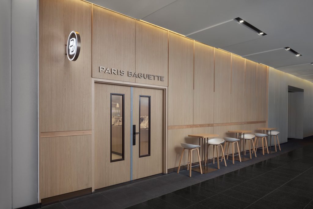 Precision-crafted architectural wood doors, custom millwork, and integrated wall paneling within a modern commercial interior.