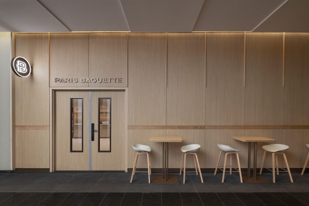 Commercial architectural millwork installation including custom service counters, wood wall systems, and specialty interior finishes.