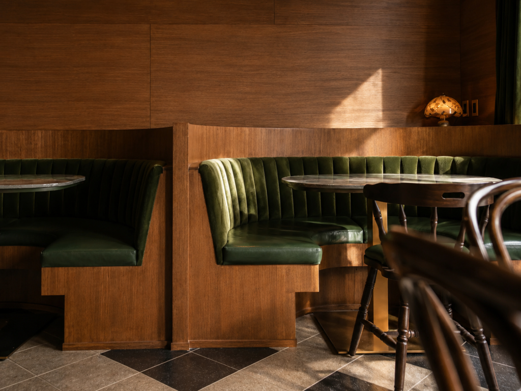 Restaurant interior featuring custom architectural millwork, handcrafted wood cabinetry, decorative wood cladding and luxury hospitality finishes.