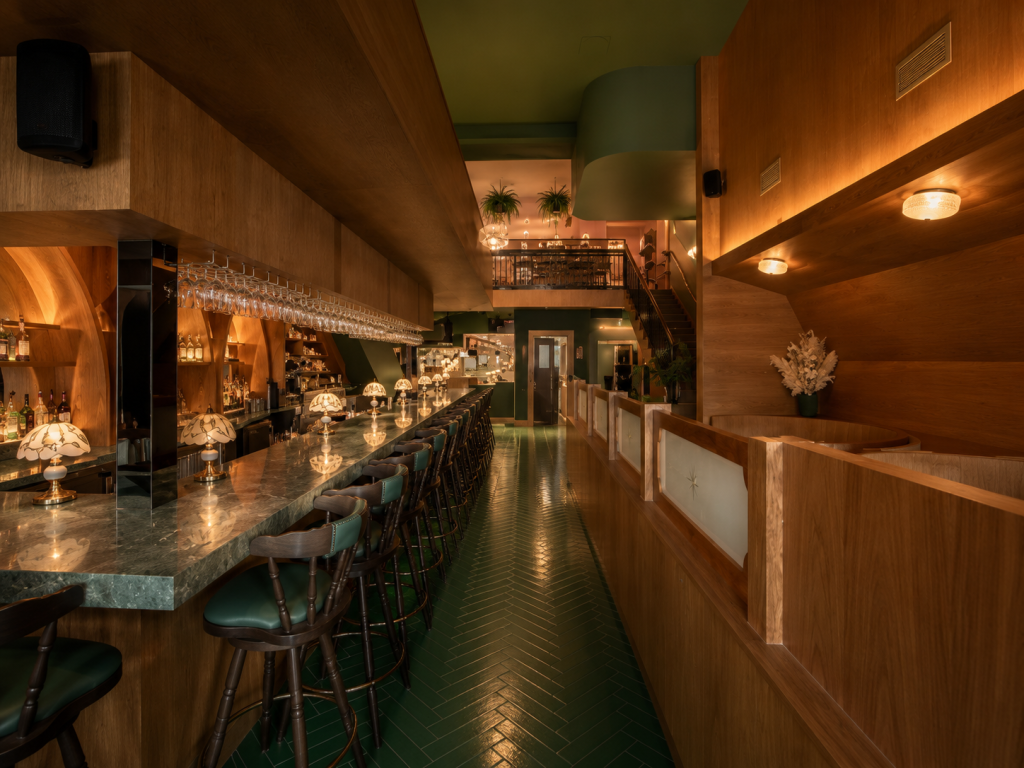 Premium commercial restaurant interior showcasing custom millwork, architectural wood finishes, feature bar cabinetry, wood wall panels and bespoke hospitality craftsmanship.