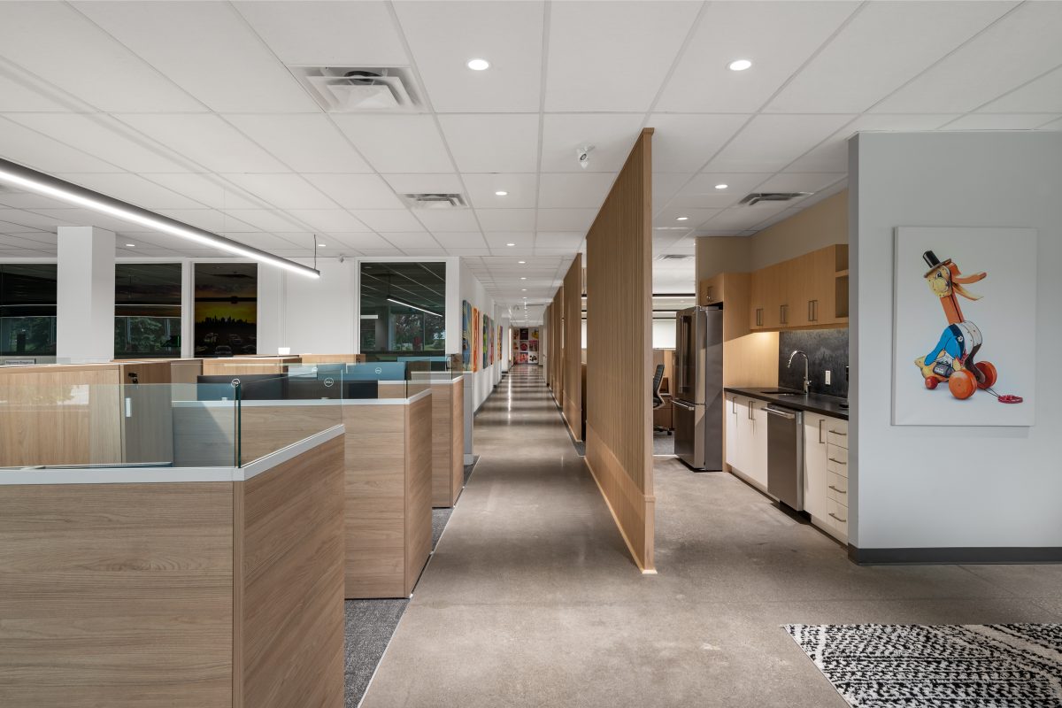 Modern commercial office showcasing premium architectural millwork, custom reception millwork, wood veneer cabinetry, and designer interior finishes.