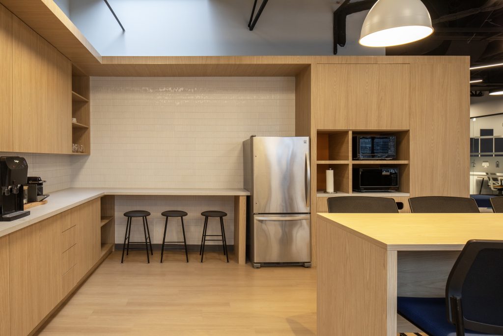 Custom office millwork including architectural wood cabinetry, integrated kitchenette, appliance surrounds, commercial storage solutions, and contemporary workplace interior crafted by Boreal Architectural.