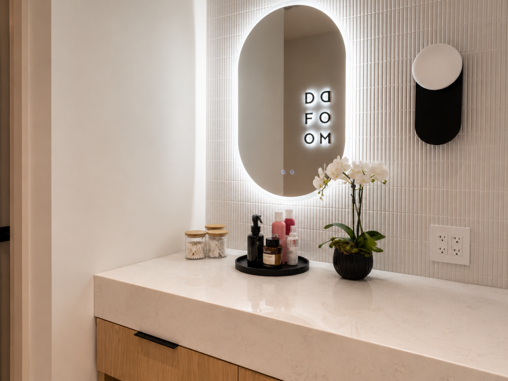 Custom commercial washroom vanity by Boreal Architectural featuring premium architectural millwork, integrated cabinetry, quartz countertop, designer mirror, and high-end commercial interior finishes.