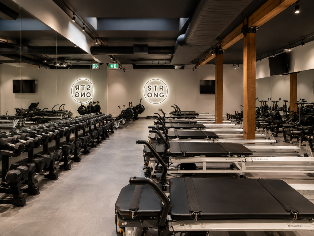 Custom architectural millwork by Boreal Architectural for a premium Pilates studio featuring integrated wood finishes, commercial interior solutions, and custom architectural details throughout the fitness facility.