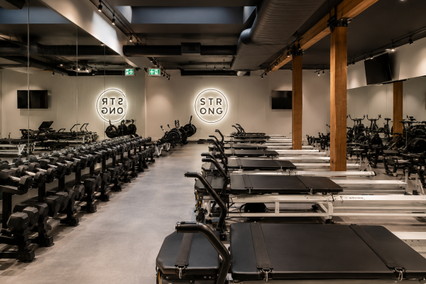 Custom architectural millwork by Boreal Architectural for a premium Pilates studio featuring integrated wood finishes, commercial interior solutions, and custom architectural details throughout the fitness facility.
