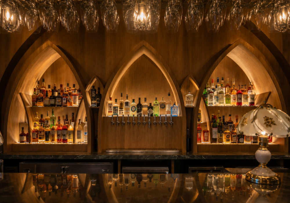 Custom restaurant bar and dining area featuring premium millwork, architectural wood finishes, custom cabinetry, integrated seating and hospitality interior construction.