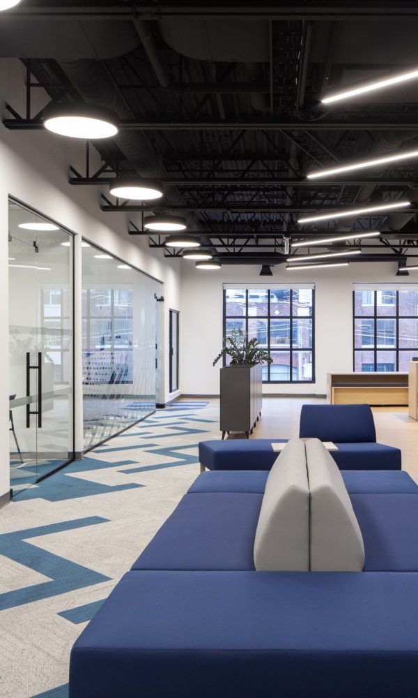 Modern corporate office interior featuring architectural glass partitions, custom wood millwork, integrated workplace finishes, premium commercial interiors, and collaborative office design constructed with Boreal Architectural millwork.